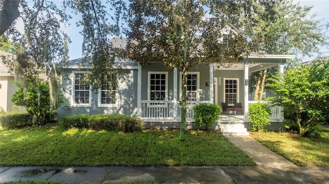 view of front of property with a porch, a front lawn, and stucco siding