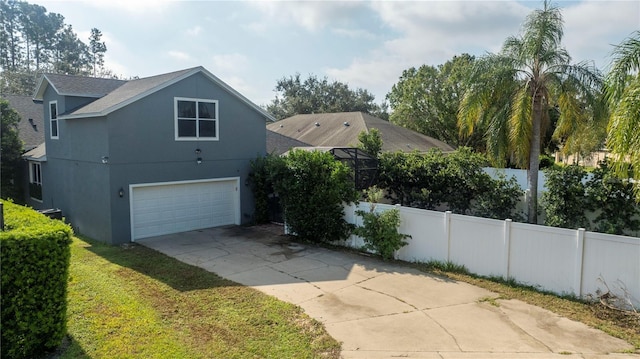 view of home's exterior featuring fence, stucco siding, a shingled roof, concrete driveway, and an attached garage