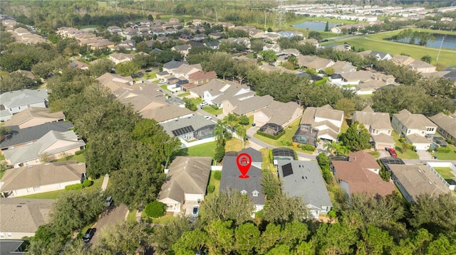 drone / aerial view with a residential view and a water view