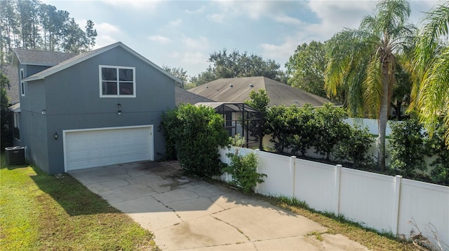 view of side of home with central air condition unit and a garage