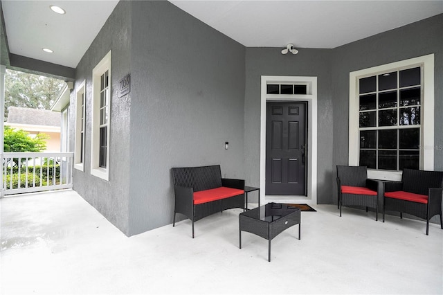 doorway to property featuring stucco siding and a patio area