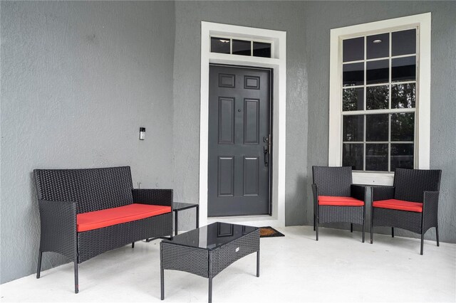 doorway to property featuring a patio and stucco siding