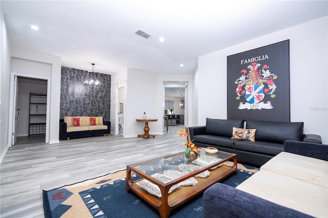 living room featuring a notable chandelier and wood-type flooring