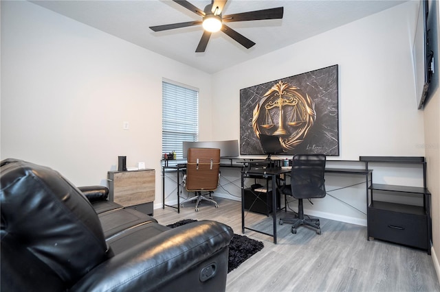 home office featuring hardwood / wood-style floors and ceiling fan