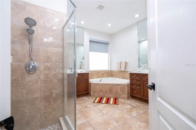 bathroom featuring vanity, independent shower and bath, and tile patterned flooring