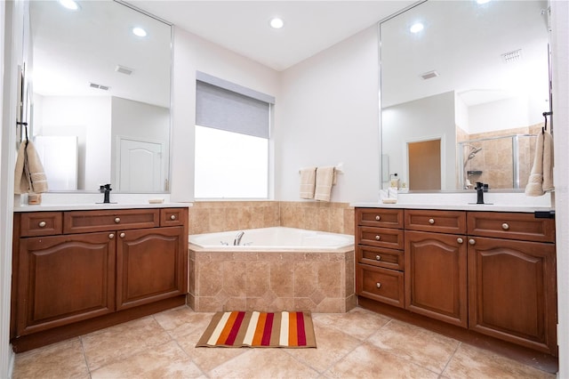 bathroom featuring vanity, shower with separate bathtub, and tile patterned flooring