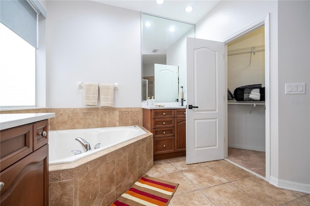 bathroom featuring vanity, shower with separate bathtub, and tile patterned flooring