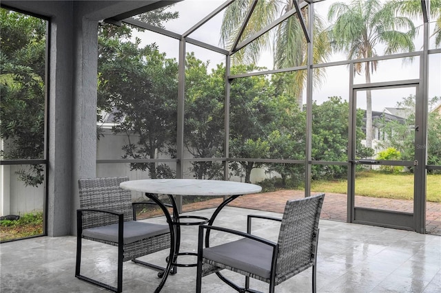 sunroom featuring outdoor dining space