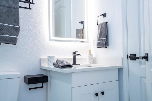 bathroom with toilet and vanity