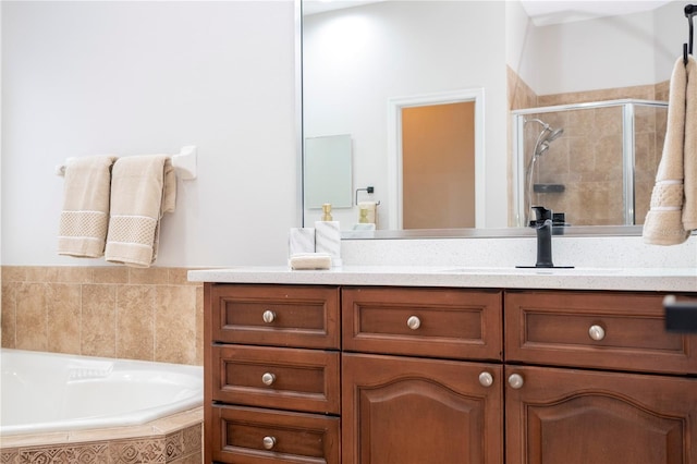 full bath featuring a garden tub, a stall shower, and vanity