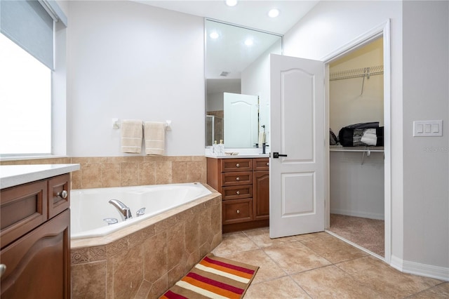 bathroom with vanity, a garden tub, recessed lighting, a spacious closet, and a shower stall