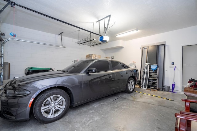 garage with concrete block wall and a garage door opener