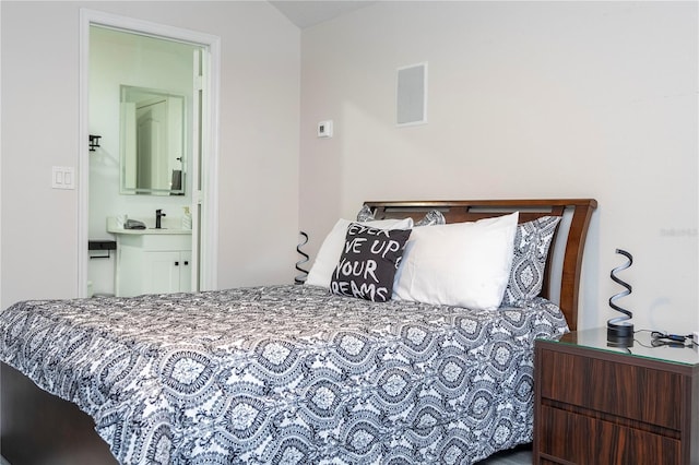 bedroom featuring visible vents and connected bathroom