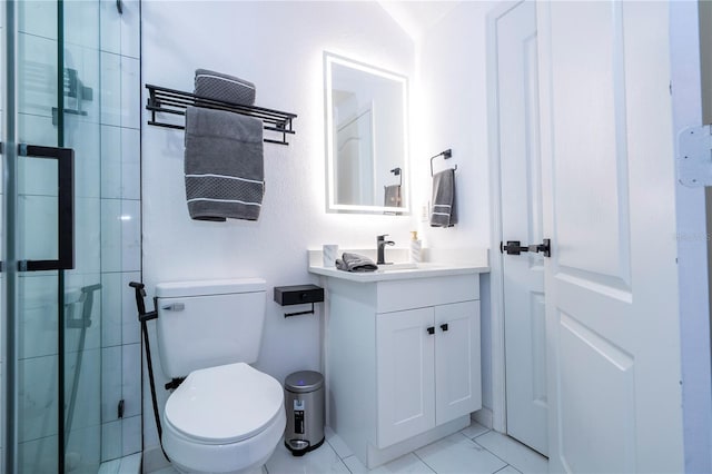bathroom featuring vanity, toilet, and tiled shower