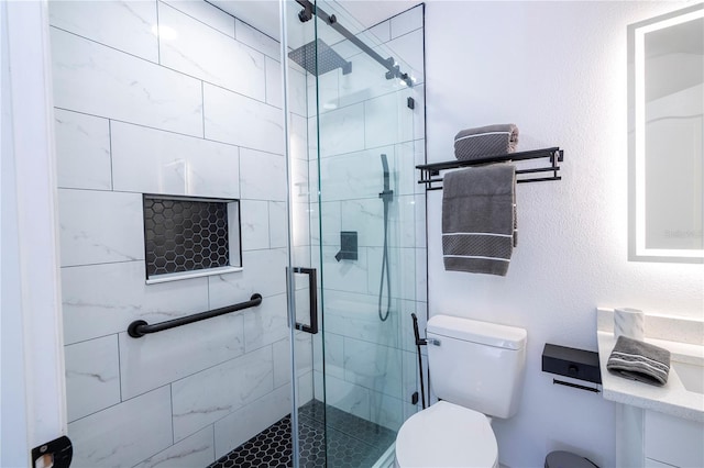 bathroom featuring toilet and a shower stall