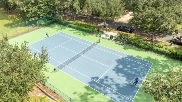 view of tennis court featuring fence