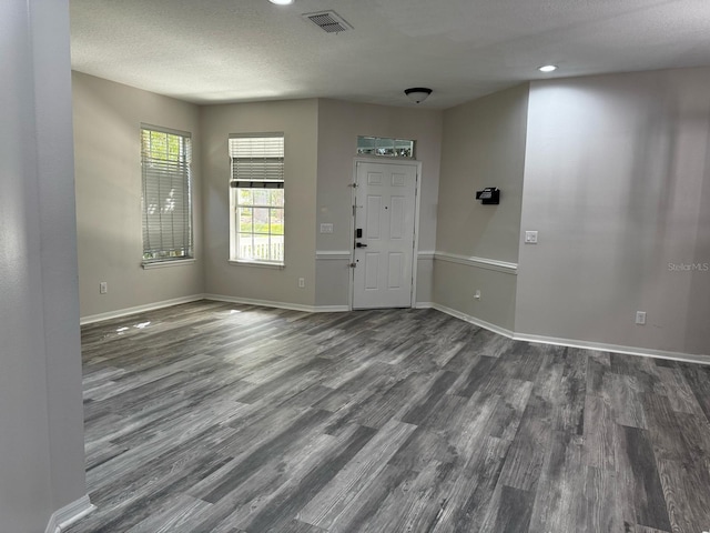 foyer entrance featuring recessed lighting, baseboards, visible vents, and dark wood-style floors