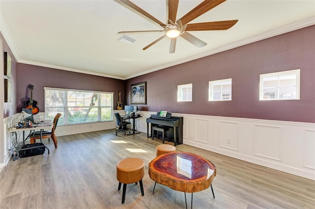 interior space featuring light hardwood / wood-style flooring, ceiling fan, and ornamental molding