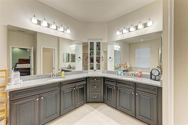 bathroom with tile patterned flooring and vanity