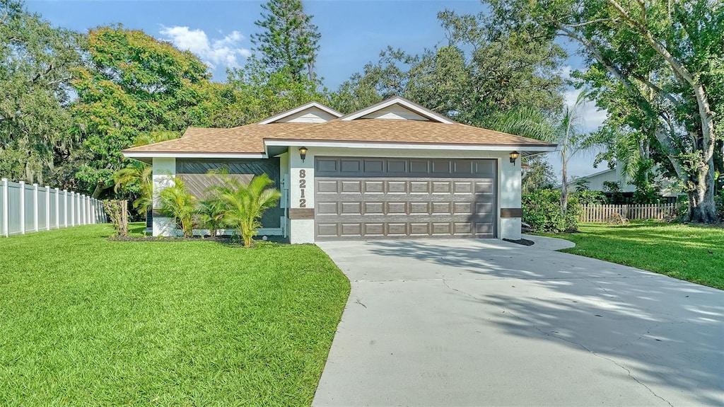 view of front of property with a garage and a front yard