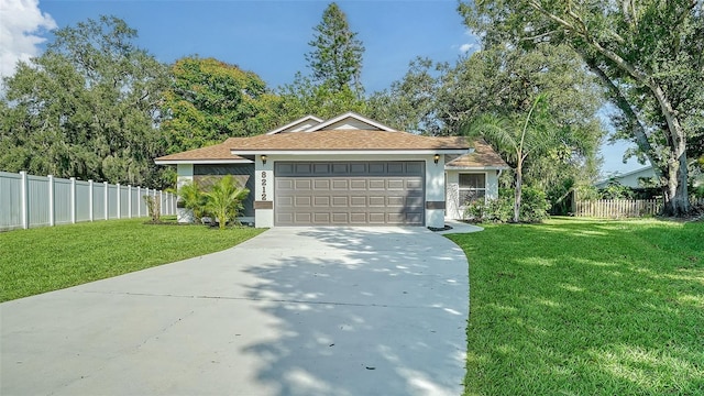 single story home with a garage and a front lawn