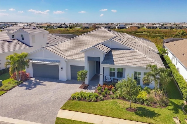 view of front of house with a front yard and a garage