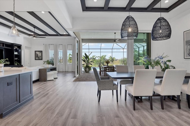 dining room featuring beamed ceiling, light hardwood / wood-style flooring, ceiling fan, and plenty of natural light