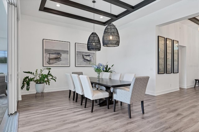 dining room with light hardwood / wood-style floors and beam ceiling