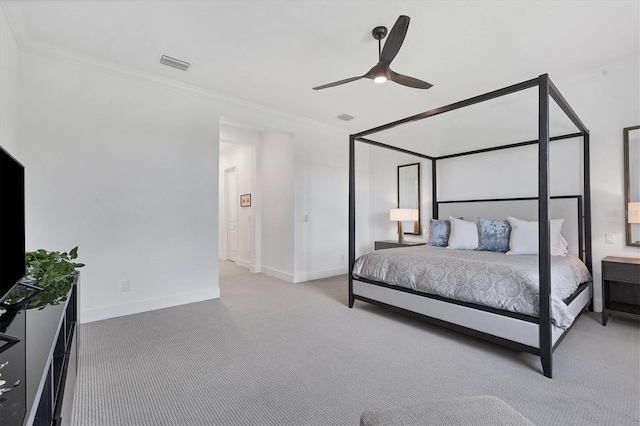 carpeted bedroom featuring ornamental molding and ceiling fan