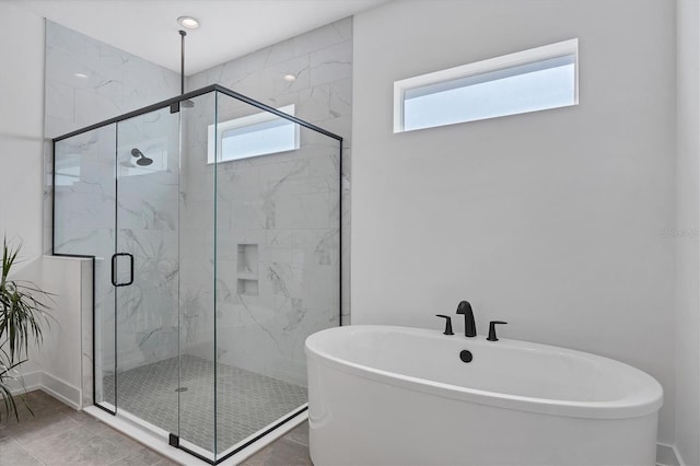 bathroom featuring shower with separate bathtub, a healthy amount of sunlight, and tile patterned floors