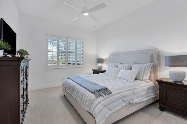 carpeted bedroom with vaulted ceiling and ceiling fan