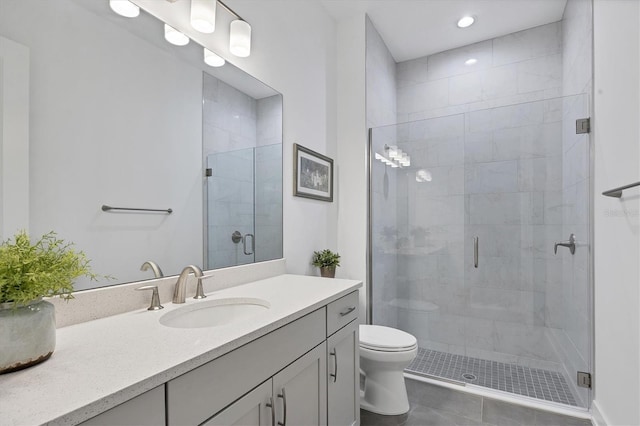 bathroom with vanity, walk in shower, toilet, and tile patterned floors