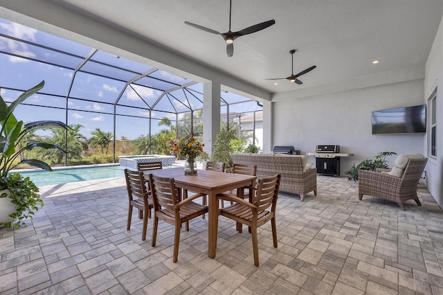 view of patio with grilling area, an outdoor hangout area, a swimming pool with hot tub, glass enclosure, and ceiling fan