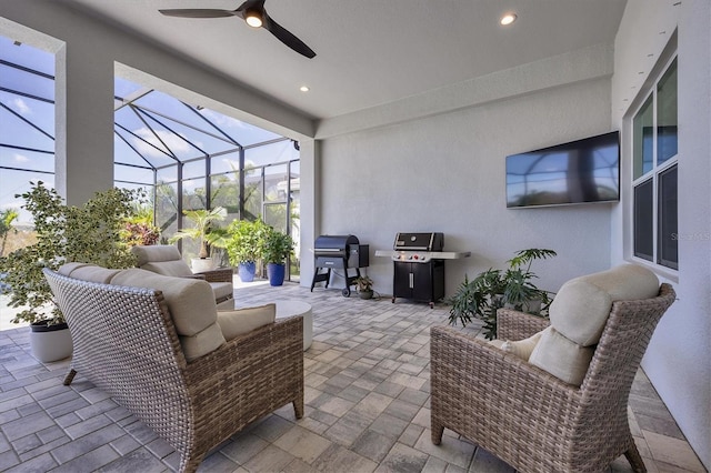 view of patio featuring ceiling fan, a lanai, an outdoor hangout area, and a grill