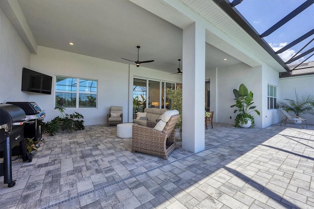 view of patio / terrace with an outdoor living space, area for grilling, a lanai, and ceiling fan