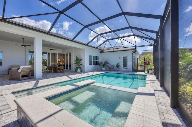 view of pool with an in ground hot tub, a patio, a lanai, an outdoor hangout area, and ceiling fan