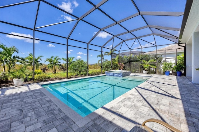 view of swimming pool featuring an in ground hot tub, a patio, and a lanai