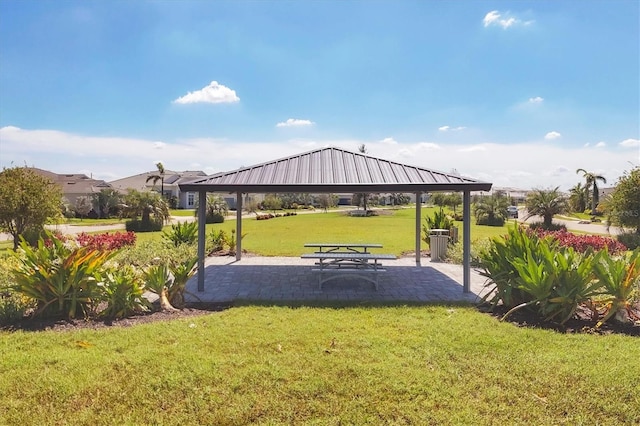 view of home's community with a yard, a gazebo, and a patio