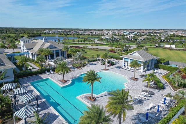 view of swimming pool with a water view and a patio