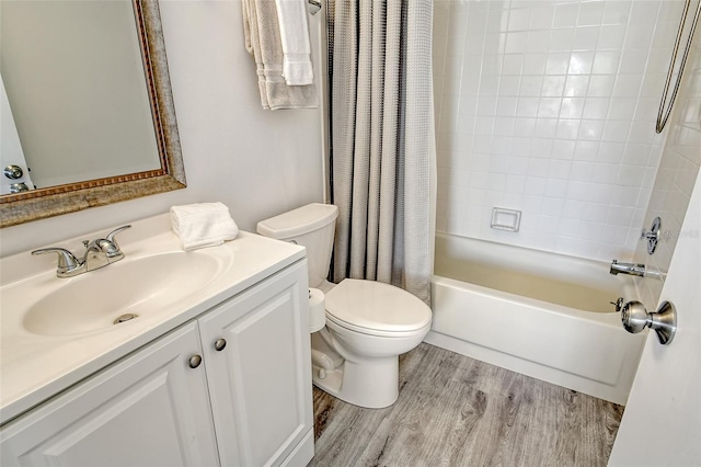 full bathroom with hardwood / wood-style floors, vanity, toilet, and shower / tub combo with curtain