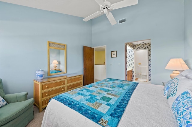 bedroom featuring connected bathroom, ceiling fan, carpet floors, and a high ceiling