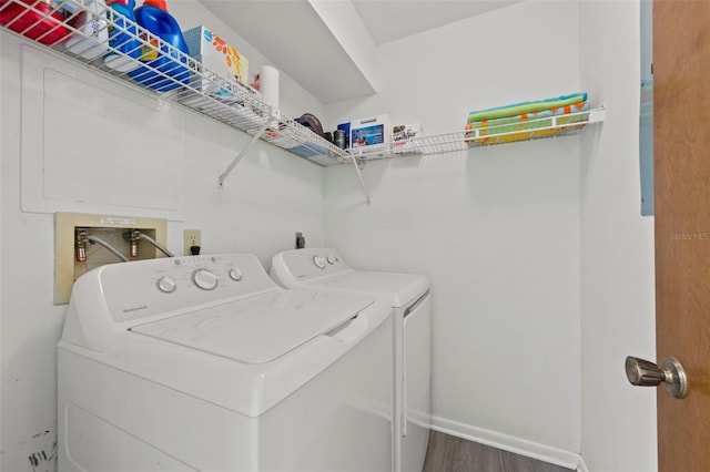 laundry room with washer and clothes dryer and dark hardwood / wood-style flooring