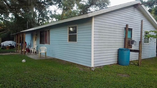 view of side of property with a yard