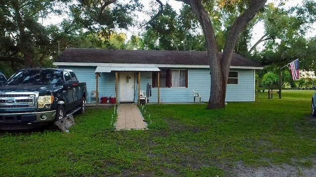 single story home featuring a front yard