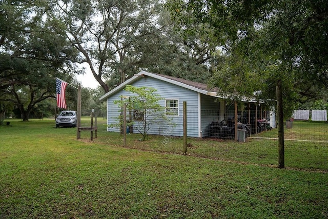 view of side of property featuring a yard