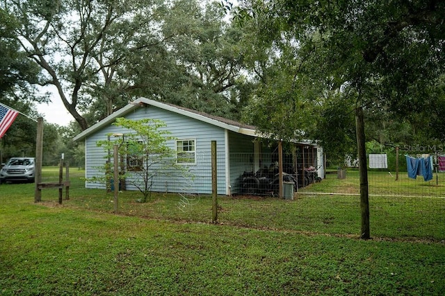 view of side of home featuring a lawn