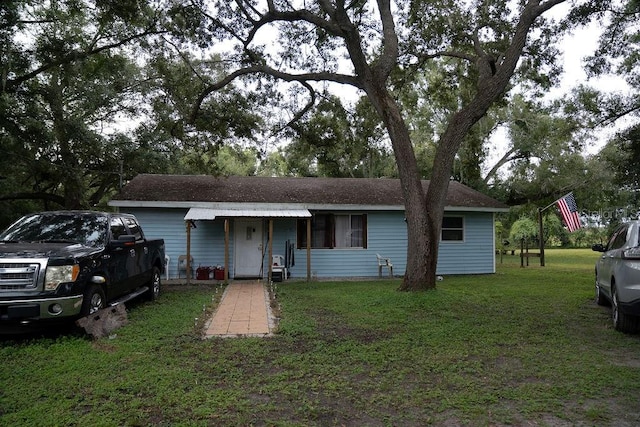 ranch-style home with a front lawn