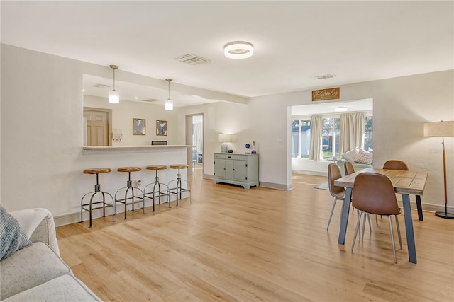 dining area with light hardwood / wood-style floors