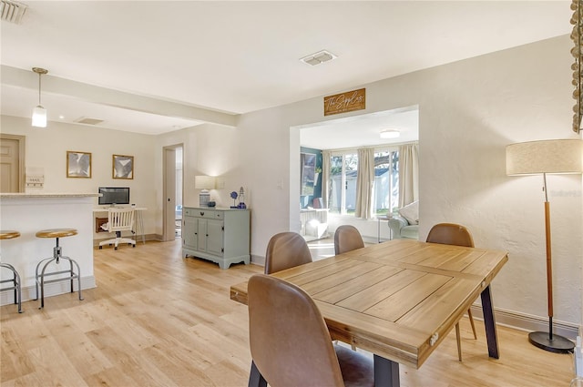 dining area with light hardwood / wood-style floors