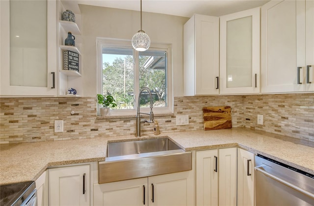 kitchen featuring sink, tasteful backsplash, pendant lighting, stainless steel appliances, and light stone countertops